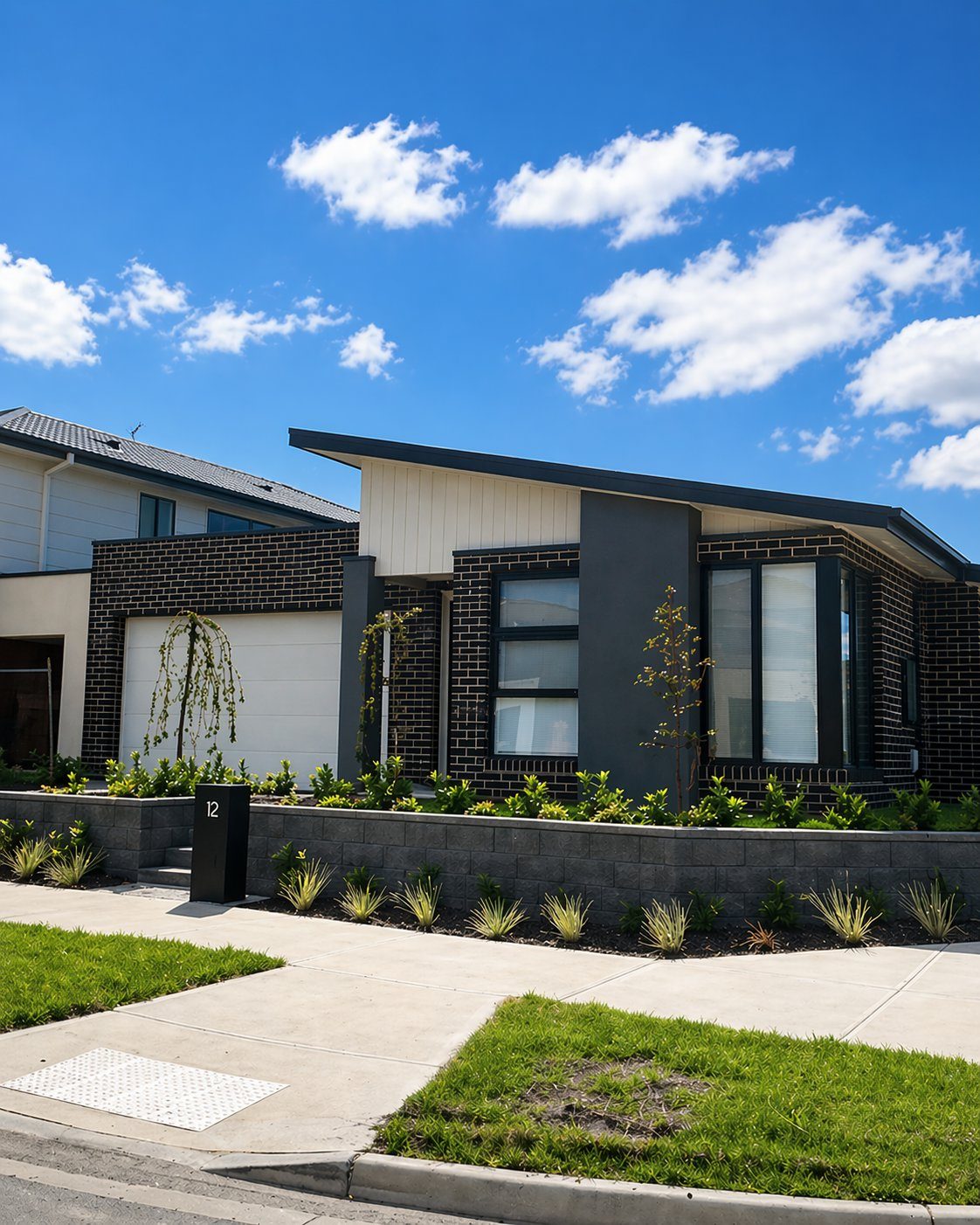 Modern home with block retaining wall and landscaping